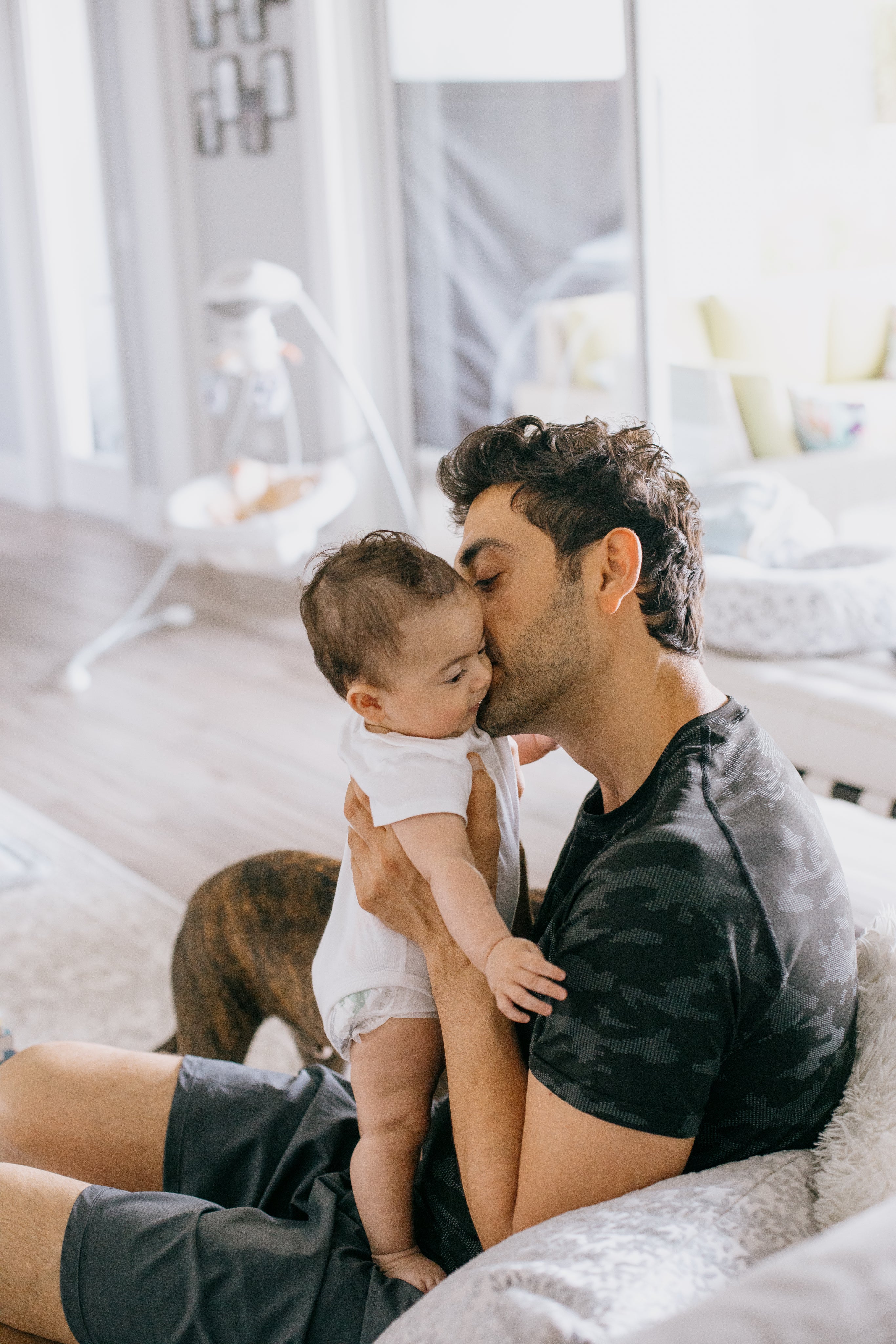 files/person-holds-a-baby-close-and-kisses-their-cheek.jpg
